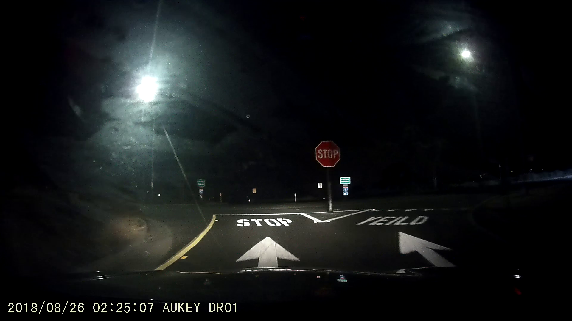 Dashcam capture with a road marking reading "YEILD"